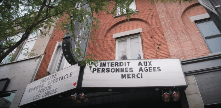 Photo de l'extérieur d'un théâtre avec un affichage indiquant interdit aux personnes âgées, merci. Extrait de la publicité du Collectif Accessibilité universelle.